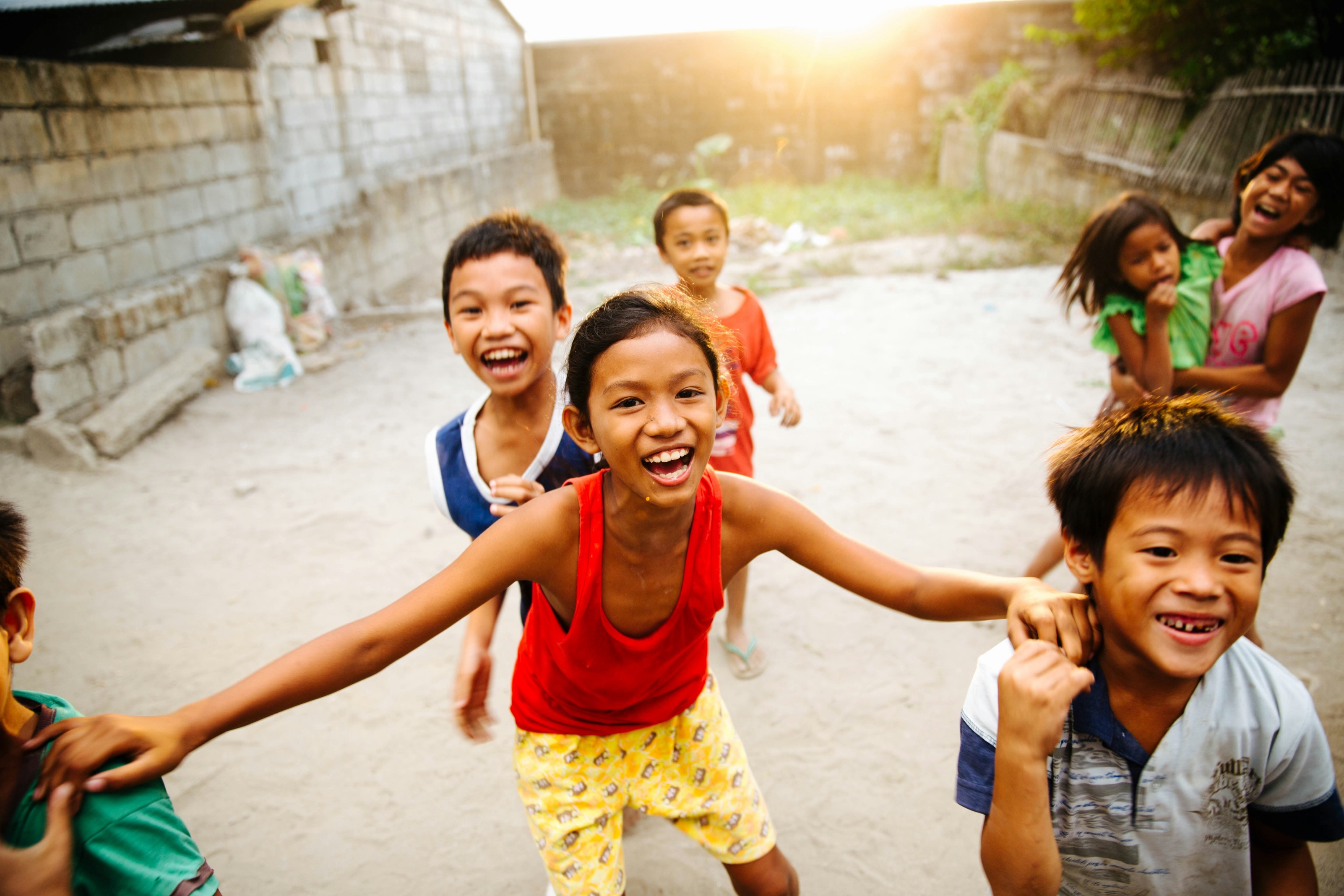 Kids playing outside running towards camera