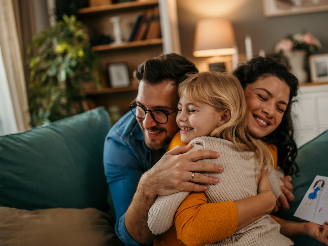 A family smiling and hugging