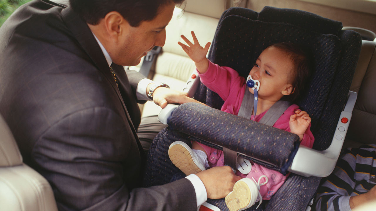 Father looking after child in van, elevated view