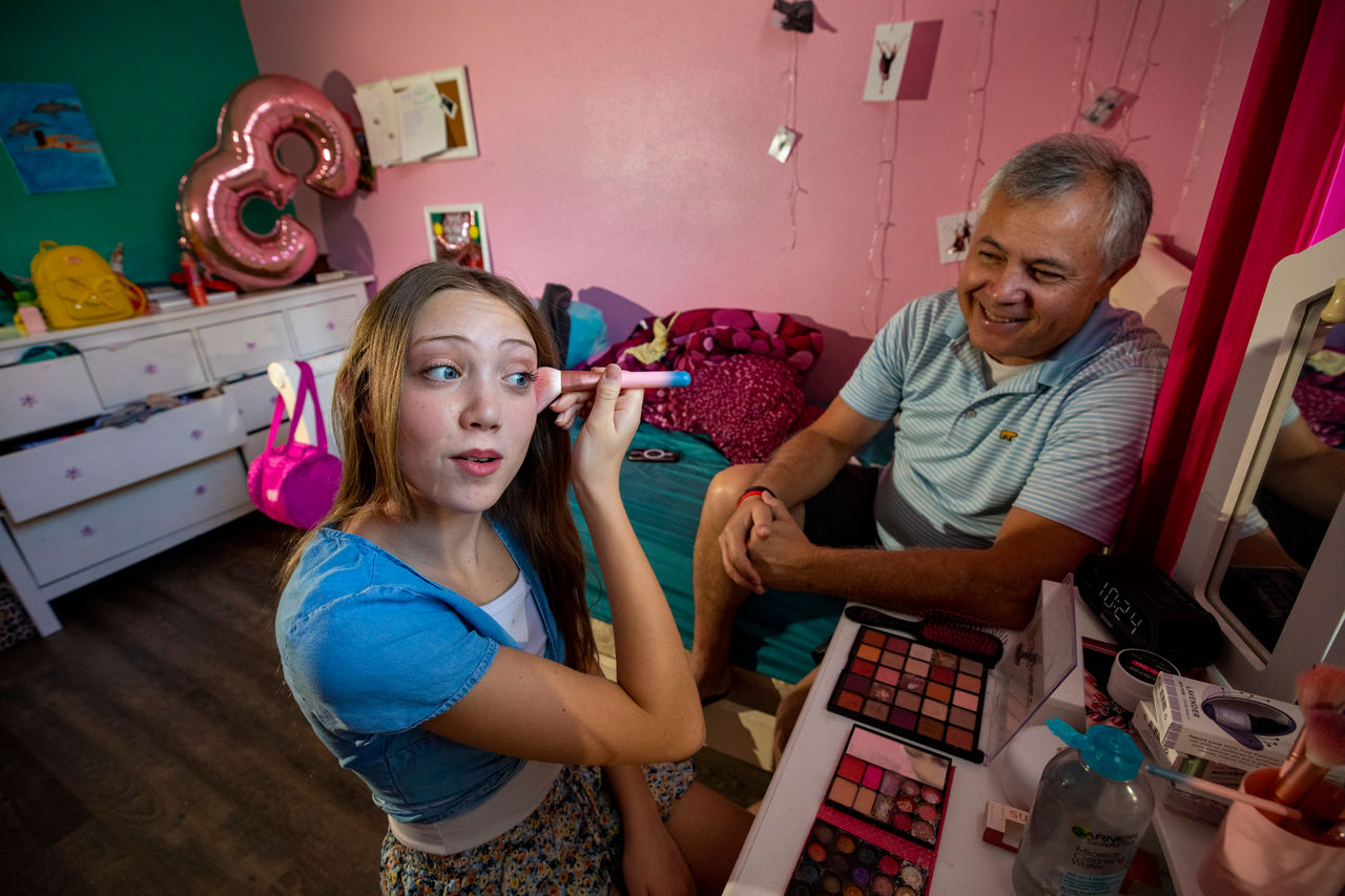 Girl shows dad how she applies makeup