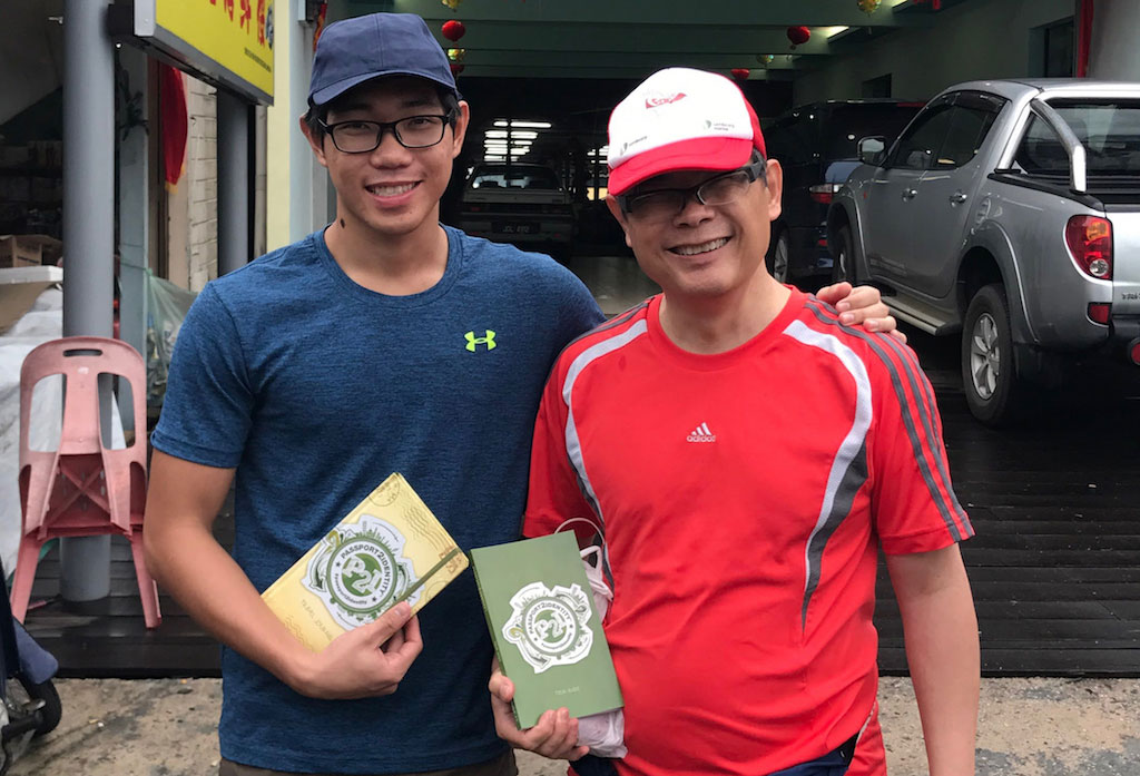 Son and father holding Passport2Identiy material